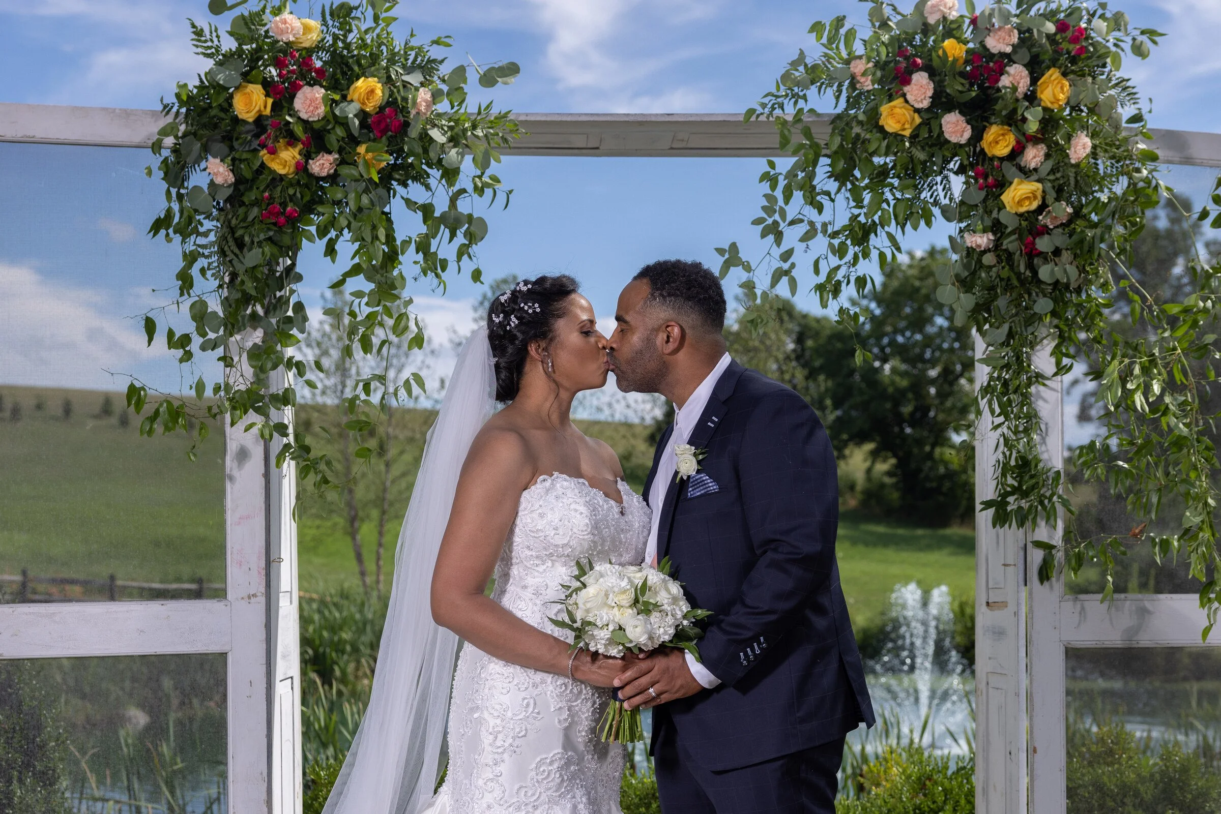 Danisha and Patrick beneath the ceremony structure at Glen Ellen Farm