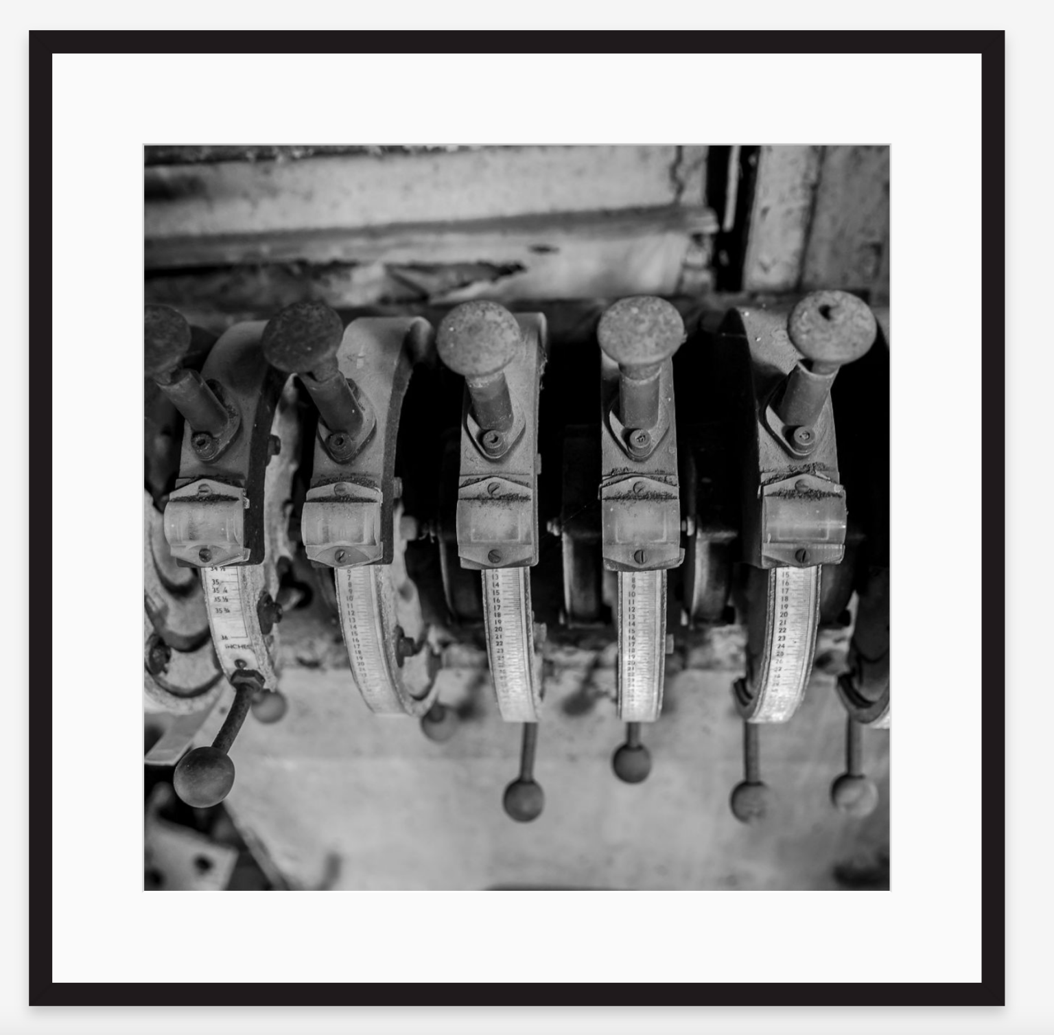 Black and white photograph of vintage music band or street performers' mechanical calliope pipes with various levers and gauges.