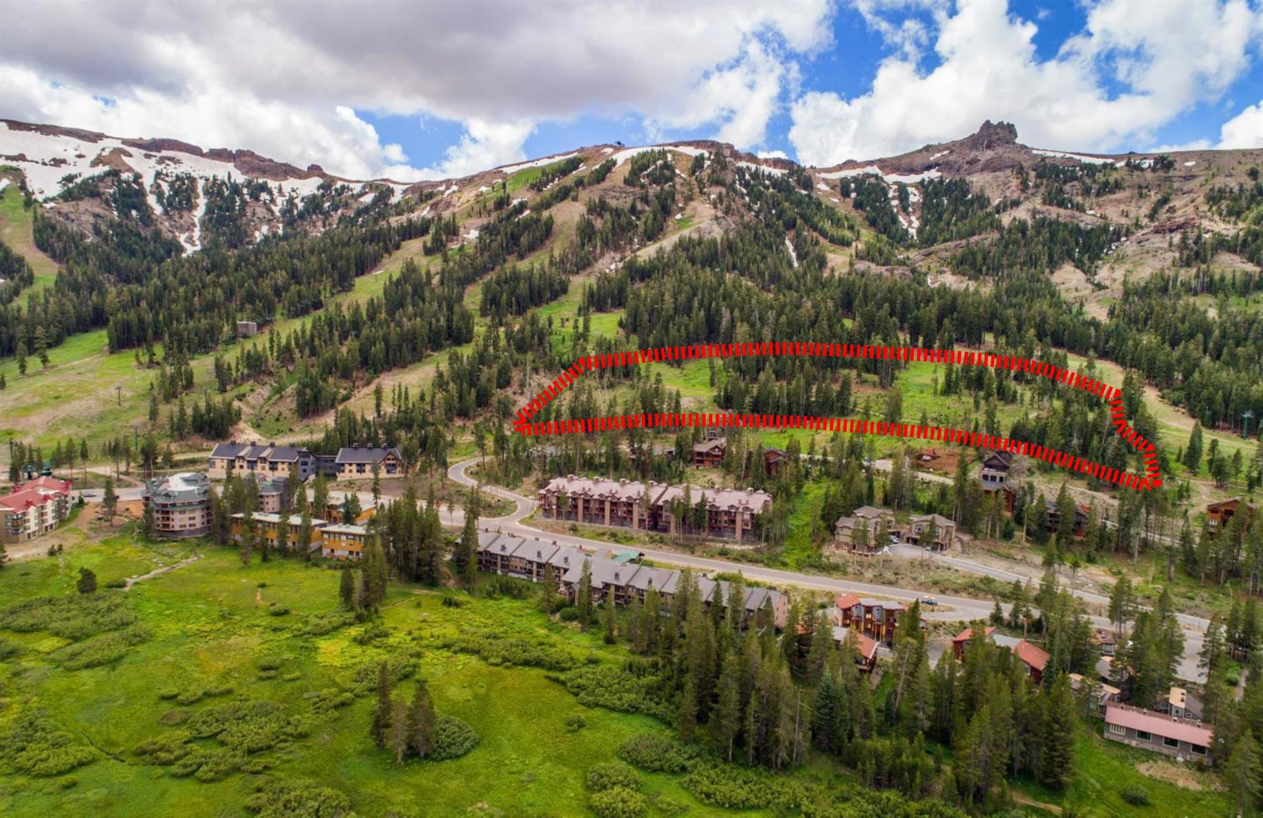 Aerial view of Kirkwood in summer, with the Haven site outlined in red on the slope above the village
