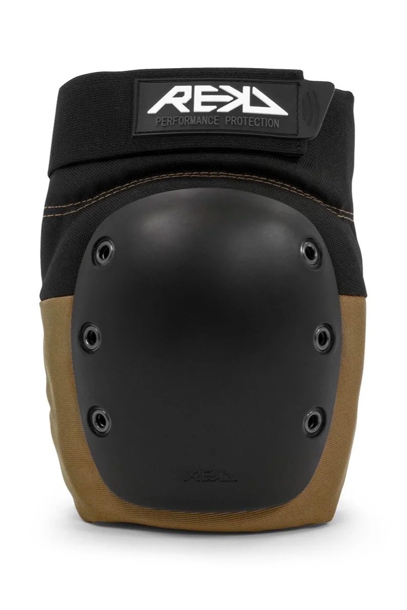 A protective knee pad with a black hard shell and brown fabric backing, branded with 'REKD' and 'Performance Protection' on the strap.