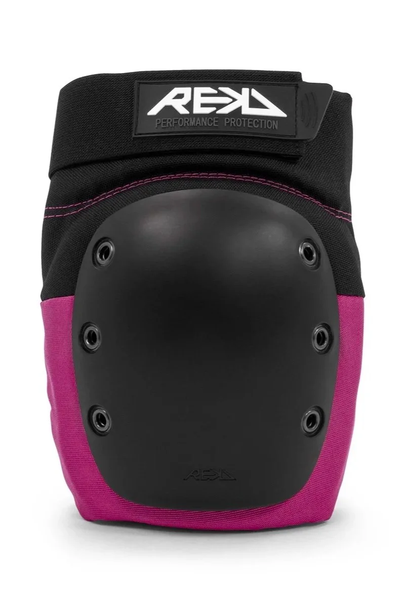 A protective knee pad with a black hard outer shell and pink fabric accents, labeled with the brand 'REKD' and 'Performance Protection'.