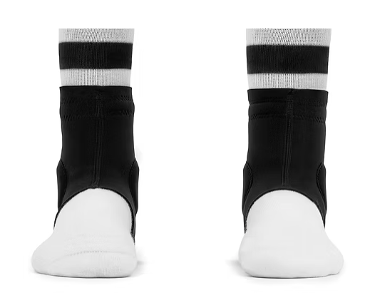 Pair of black and white athletic shoes with white socks, viewed from the front.