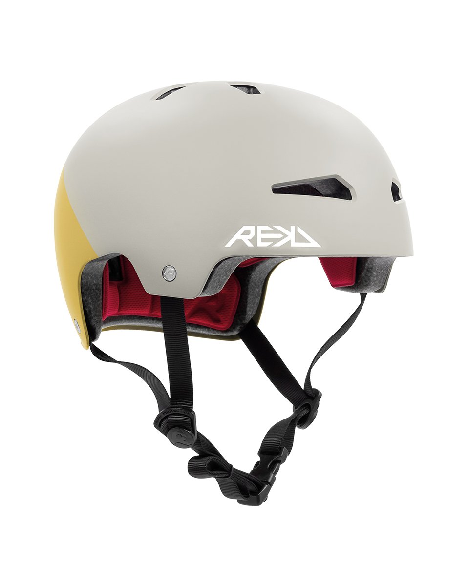 A white and yellow safety helmet with black straps and red padding, designed for sports like cycling or skateboarding.