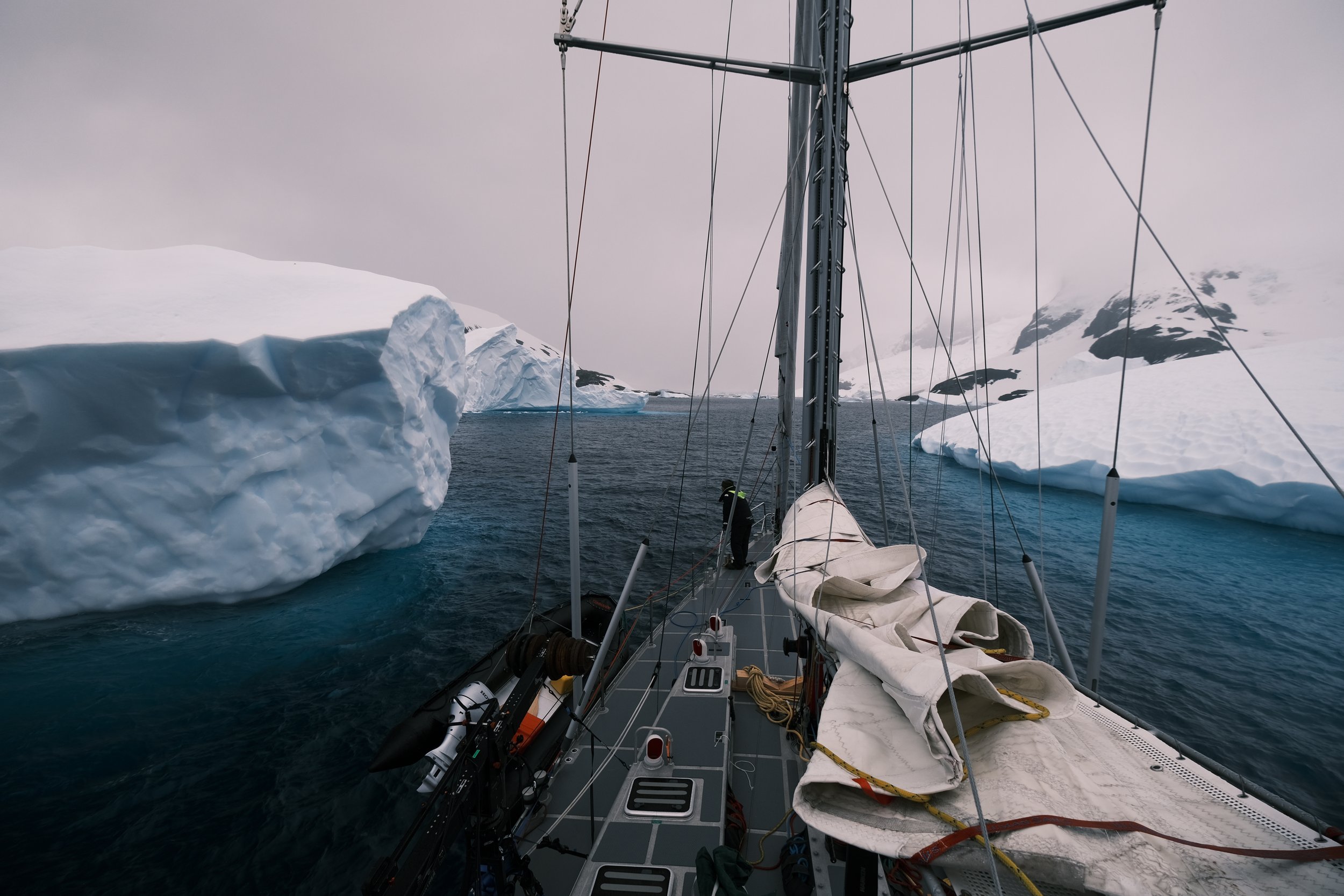 Vinson of Antarctica yacht sailing between icebergs in Antarctica. Copyright.