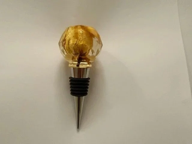 Handmade botanical wine stopper featuring a preserved yellow rose inside a clear faceted resin sphere with a silver coloured metal fitting.
