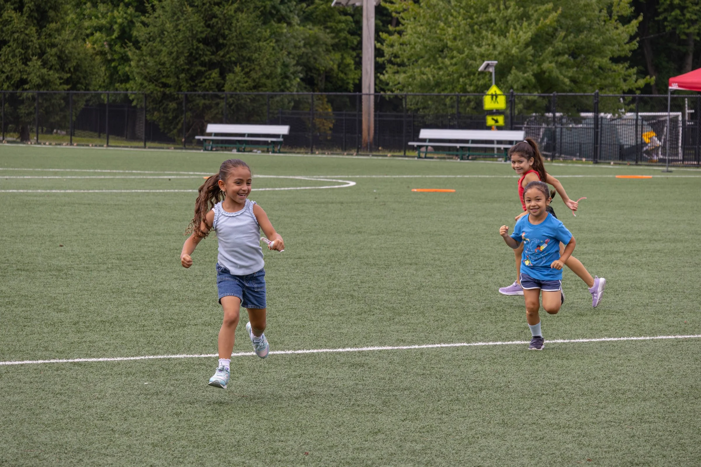 Campers racing across the field at Varsity Prep summer camp