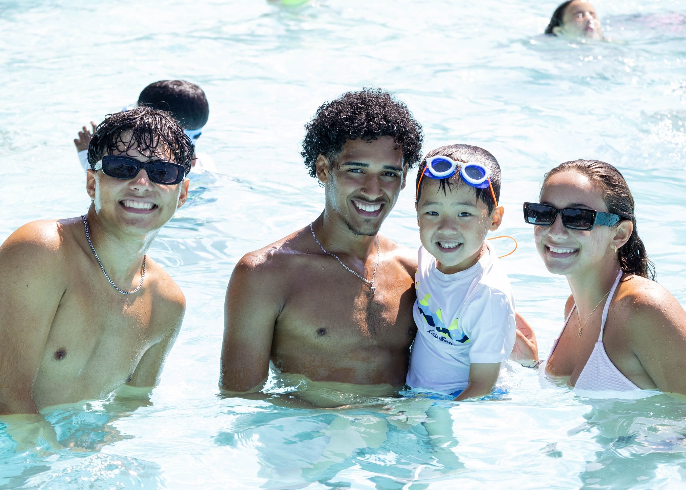 Teen staff and a camper in the pool