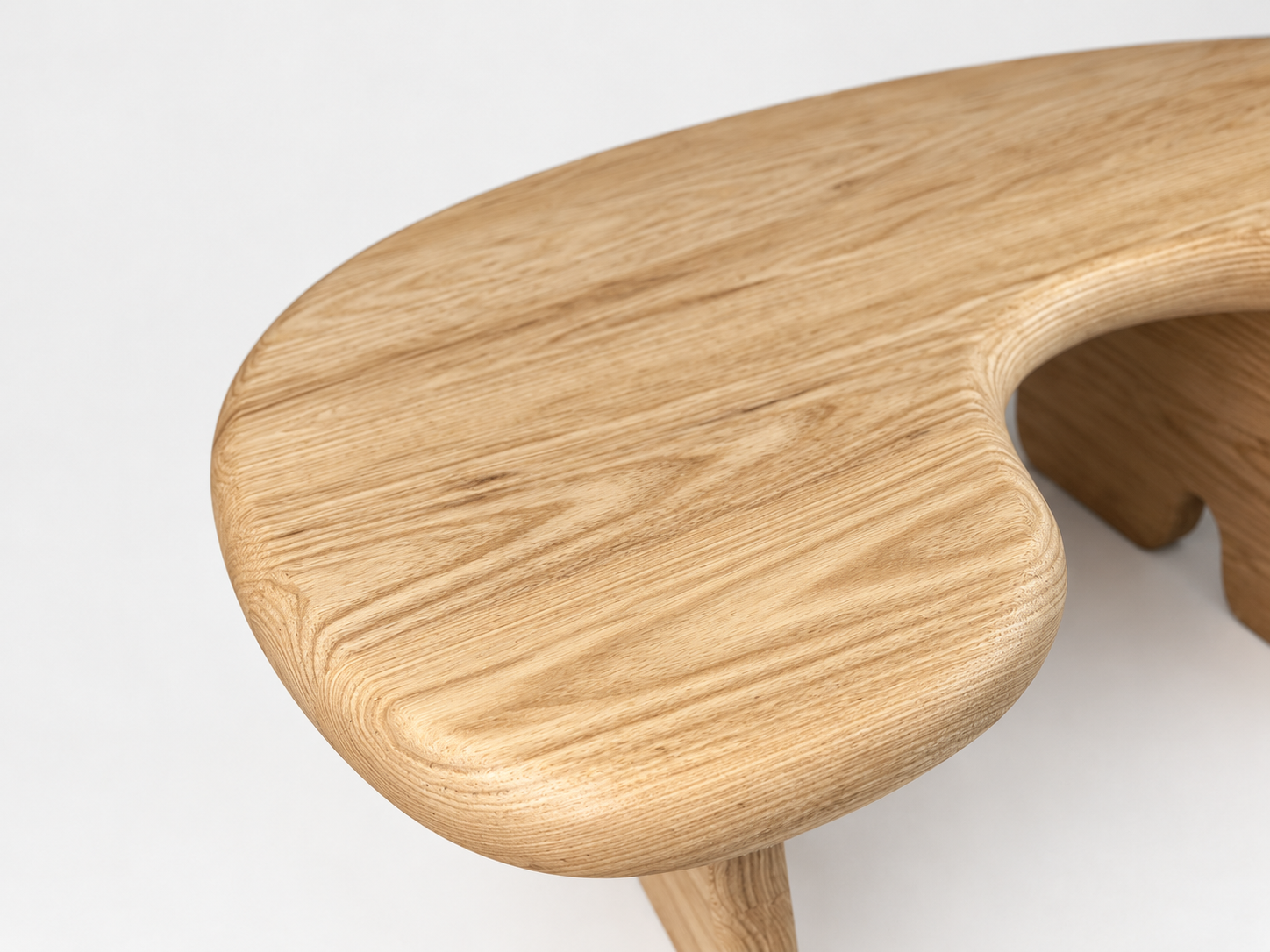 Close-up of a wooden table or stool with curved edges on a white background