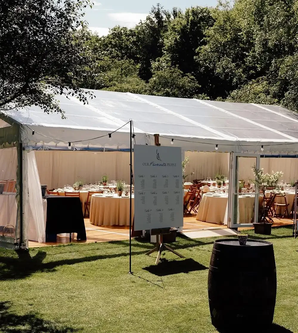 framed marquee set up with dining tables in a scottish borders based garden
