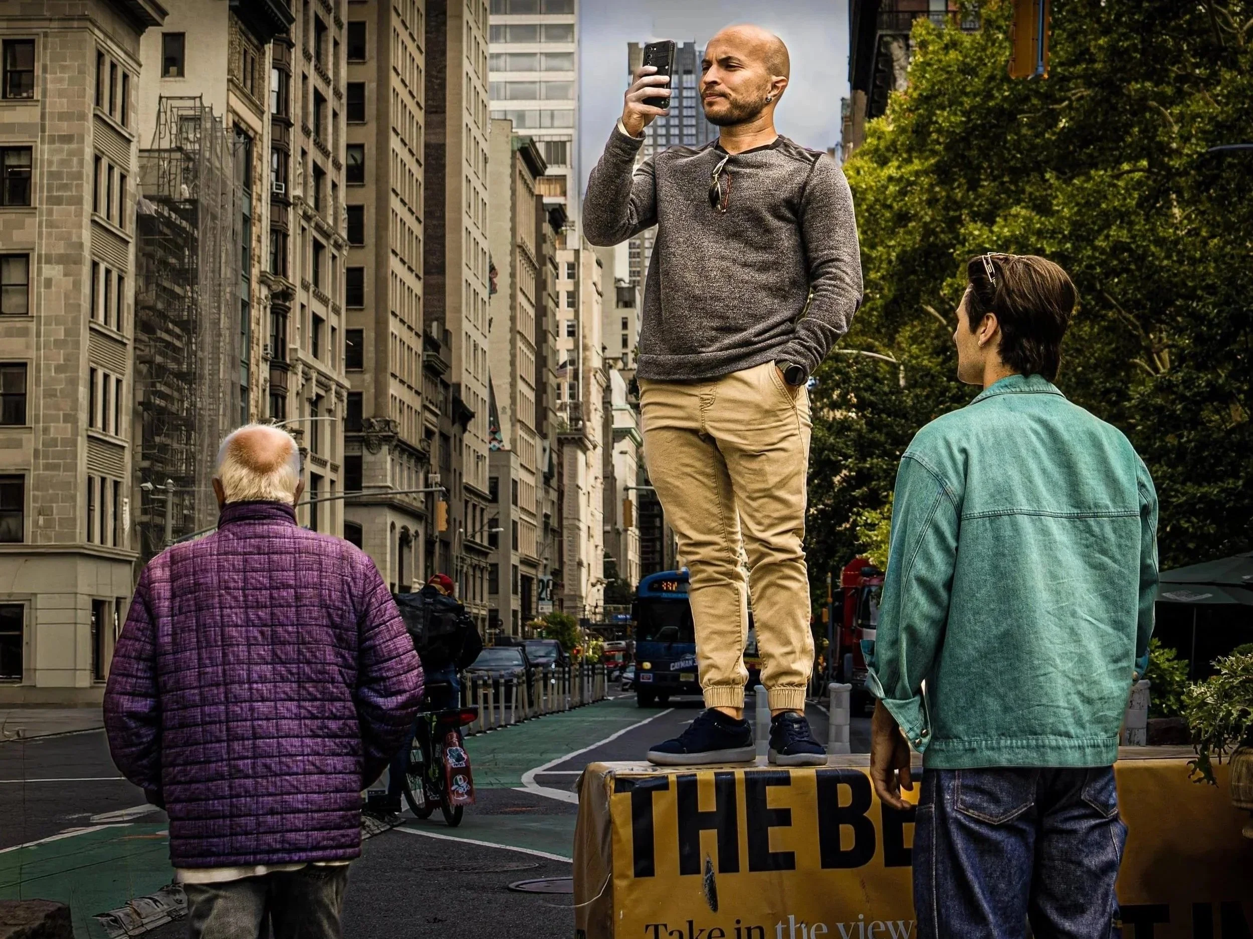 Man standing on object and videoing.jpg