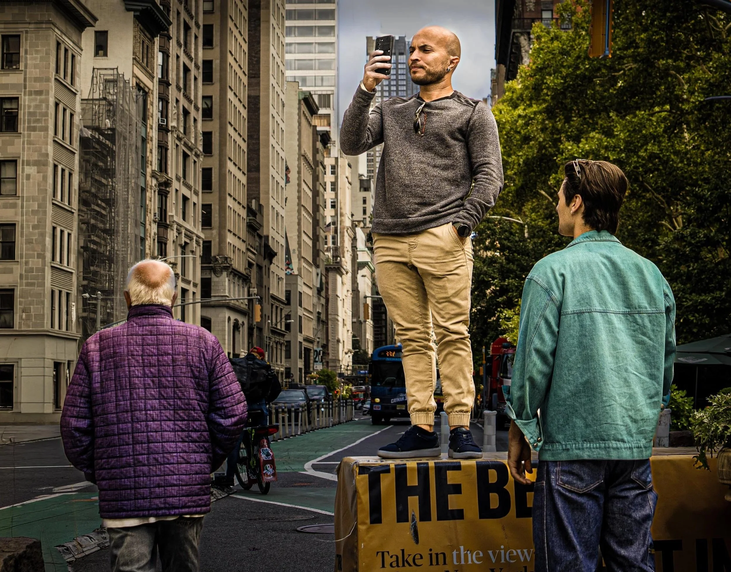 Man standing on object and videoing.jpg