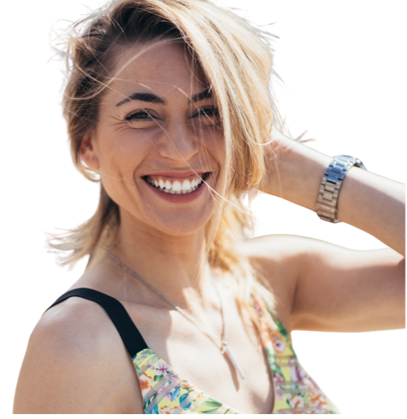 Smiling woman with her hand in her hair, looking relaxed and confident