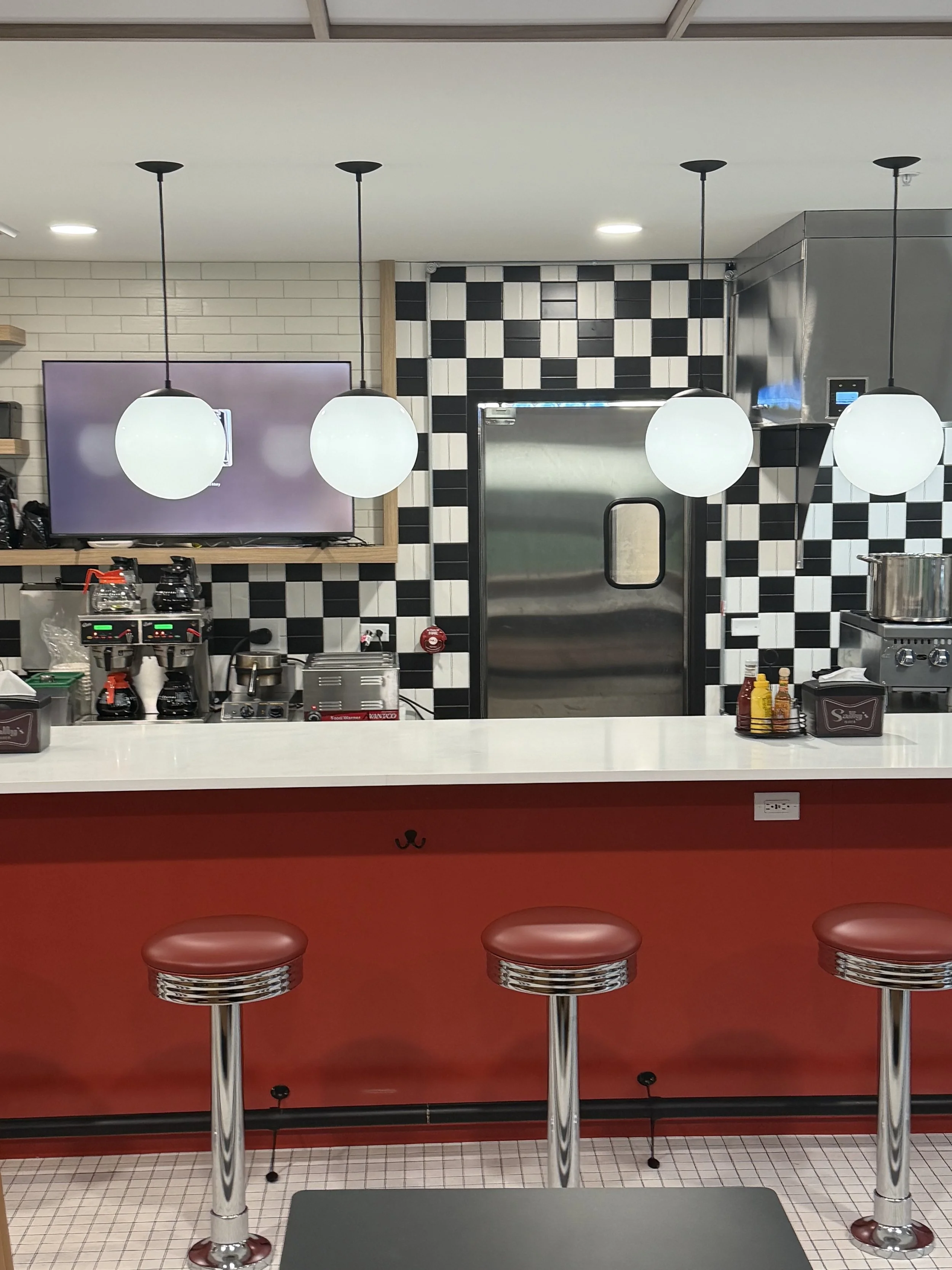 Retro diner counter with classic stools and counter seating at Sally’s Diner