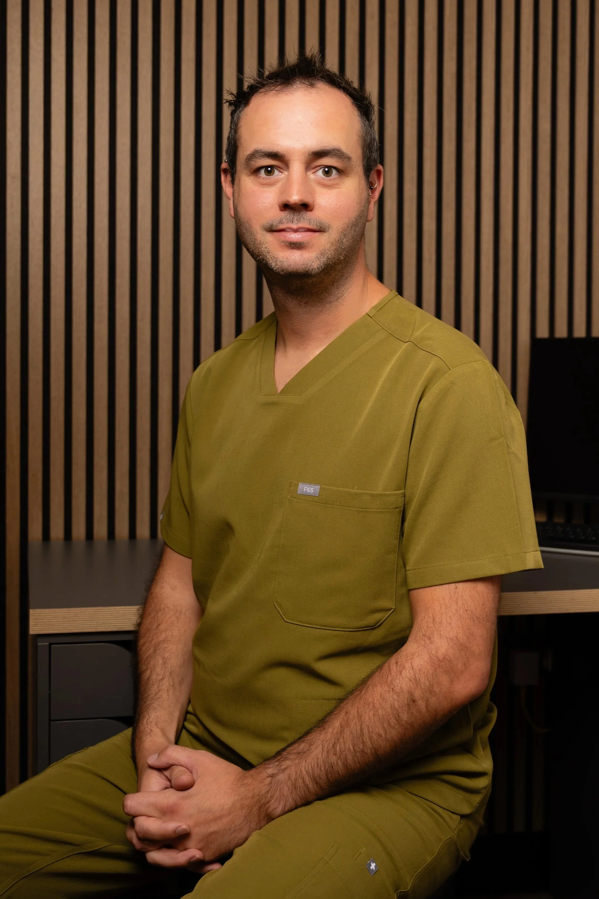 James Milner, pharmacist prescriber and aesthetic practitioner, seated in the Milner Aesthetics clinic in Halesowen.