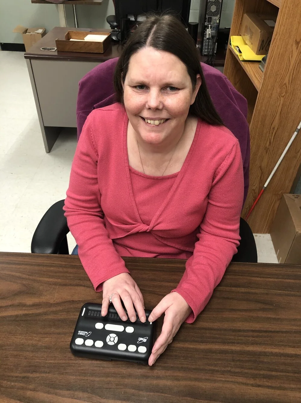 Client smiling using a braille display
