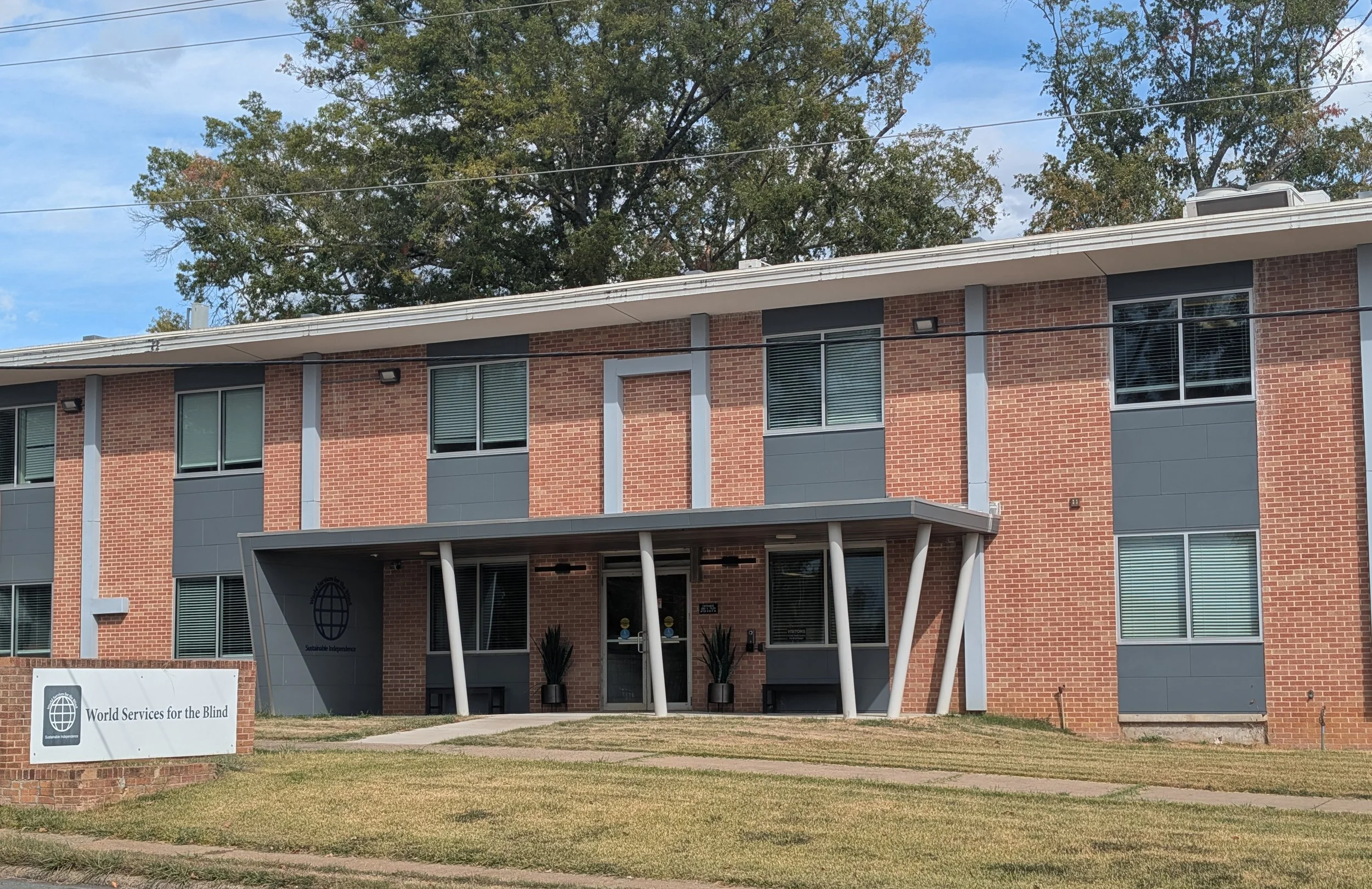 Front side of the WSB campus with a sign that reads World Services for the blind