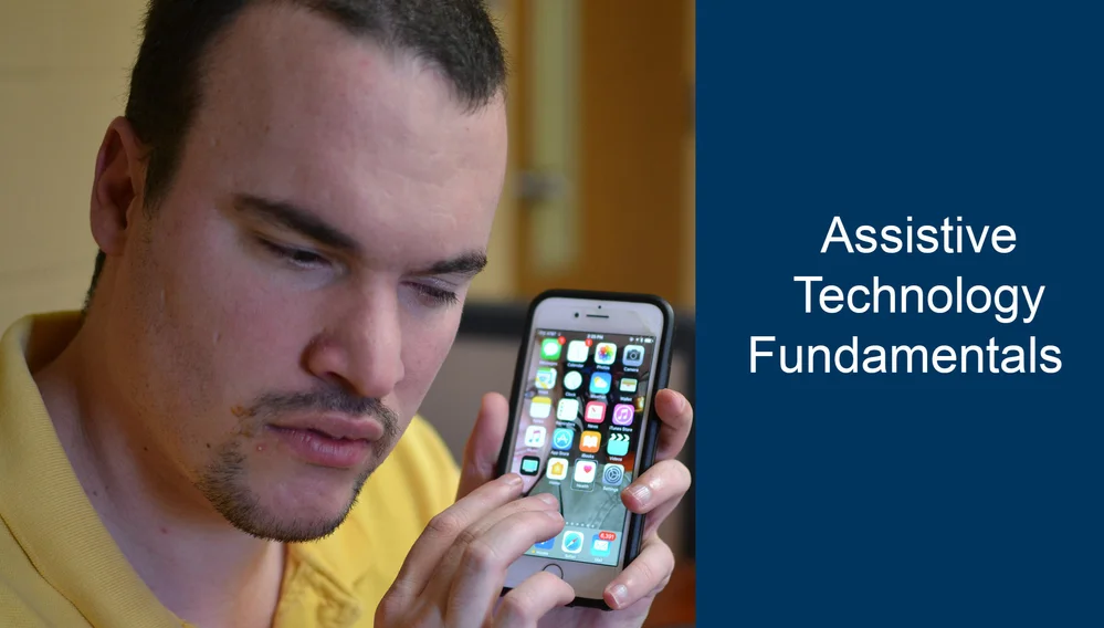 man holding an iphone near his ear gesturing as he is listening with white text on the right side that reads “assistive technology fundamentals”