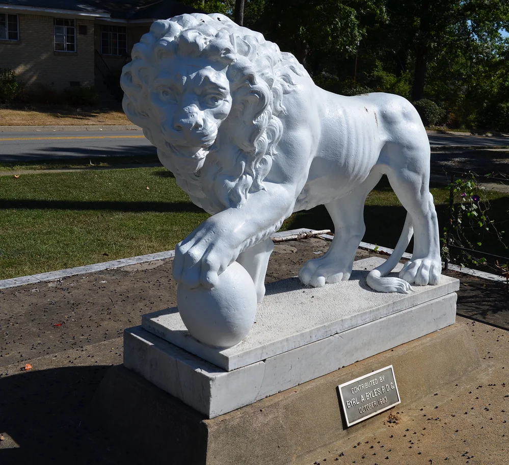Marble statue of a lion that sits on the front lawn at WSB.