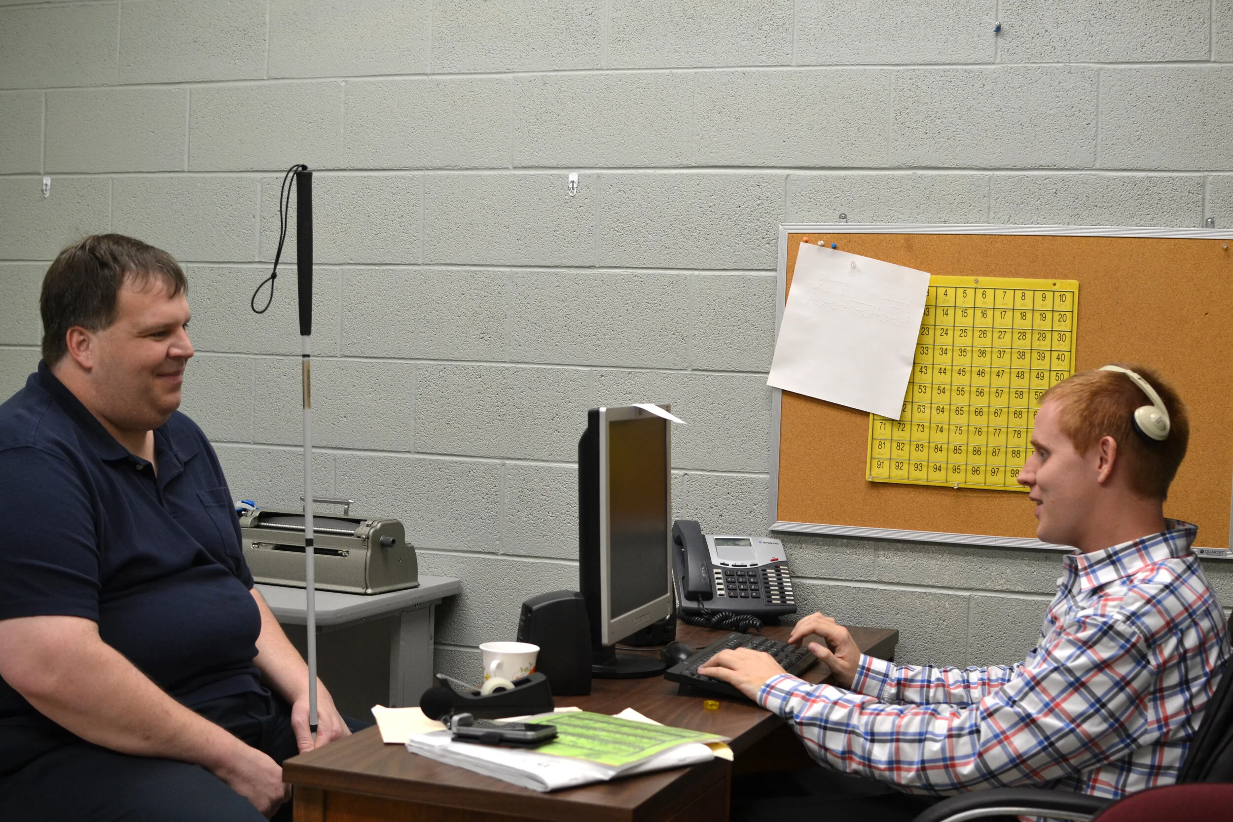 Client and staff member meeting at a desk