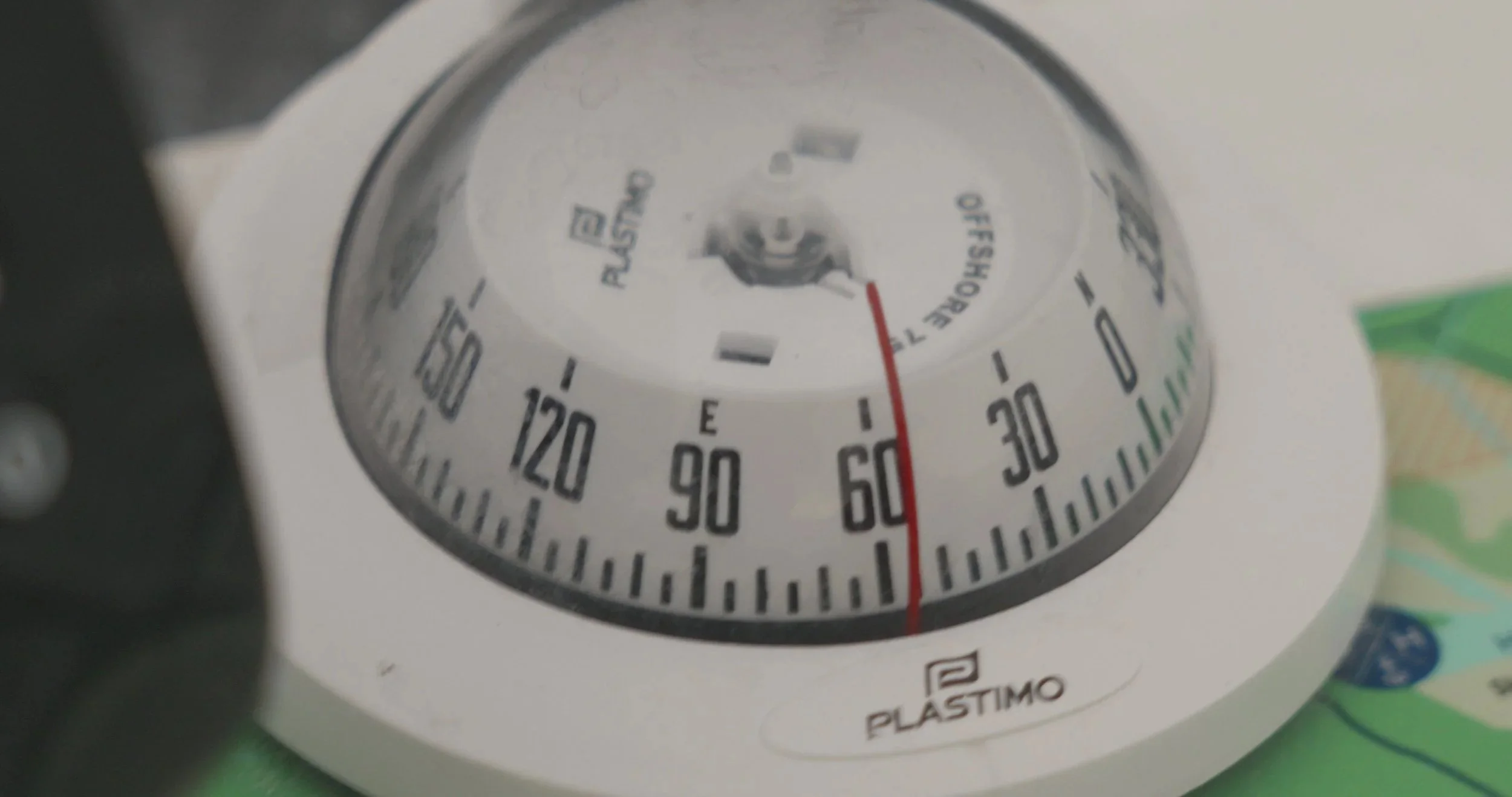 Close-up of a round plastic timer with red and black markings and labels, showing the time as approximately 25 minutes.
