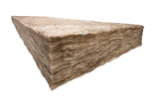 A large, rough-textured, beige-colored stone or concrete block with a trapezoidal shape.
