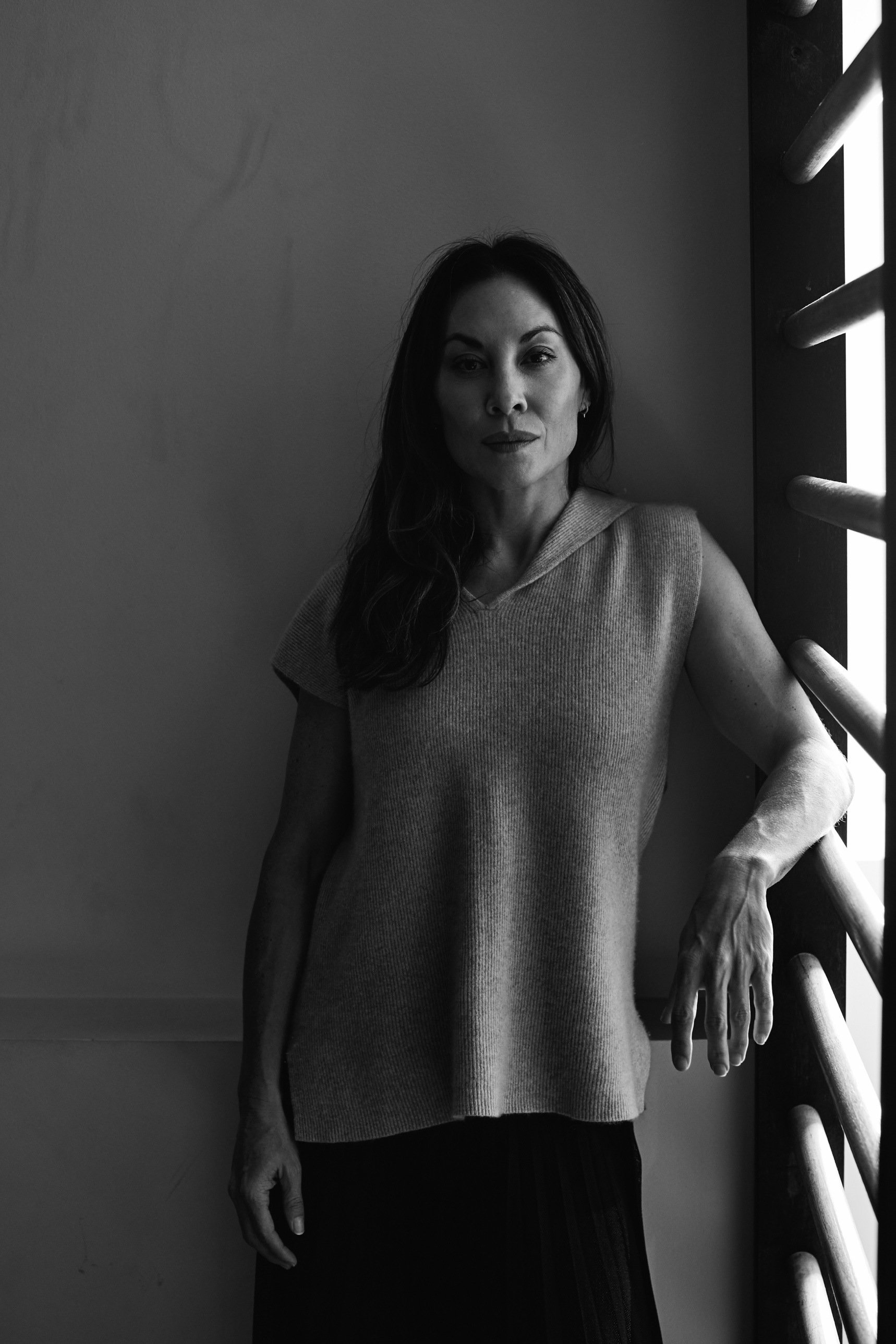 Portrait of Rebecca Tung standing beside a studio window