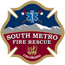 South Metro Fire Rescue badge with mountain background, firefighter tools, and a flame symbol, Colorado.