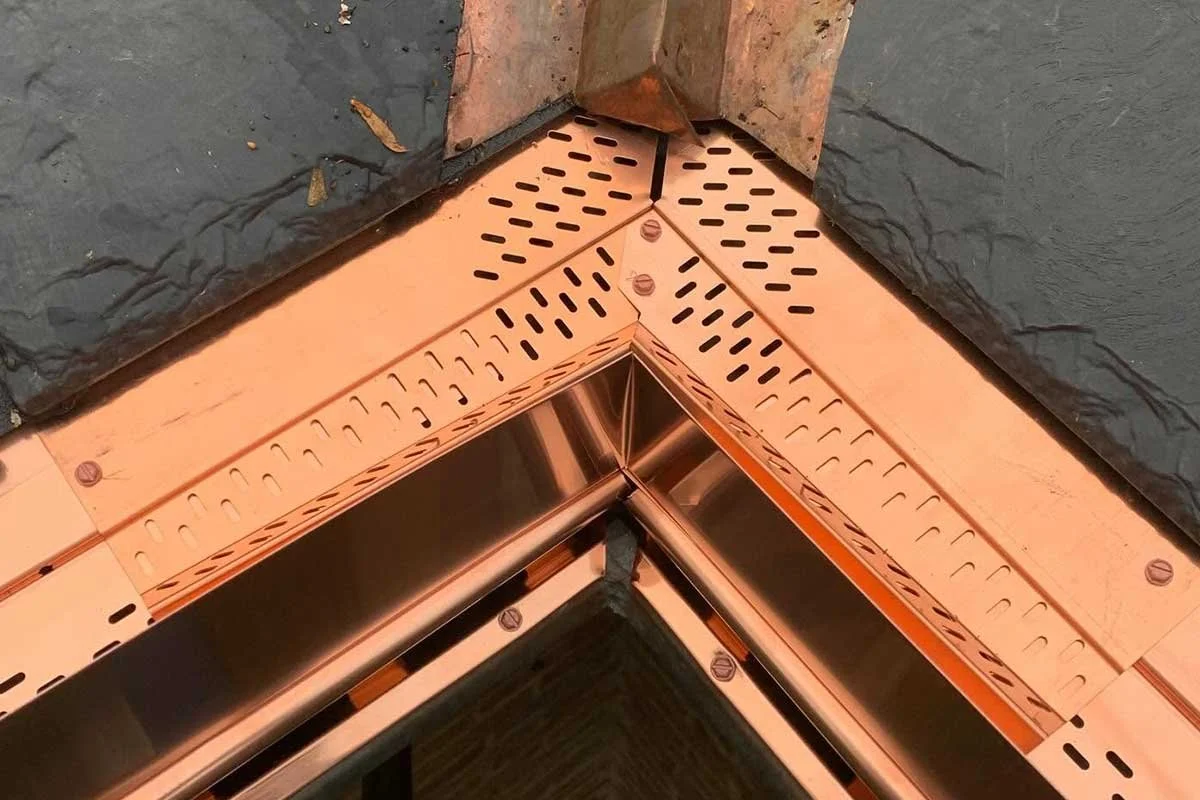 Close-up of copper LeafX gutter protection inside corner.