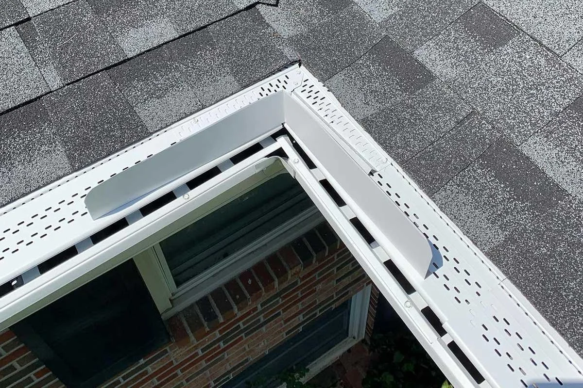 Close-up of a LeafX inside corner installation with grey shingles.