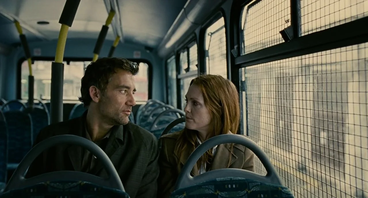 Theo and Julian sit together on a bus, speaking after nearly twenty years apart.