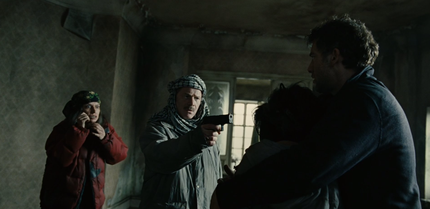 Syd threatens Theo and Kee at gunpoint while Marichka looks on.