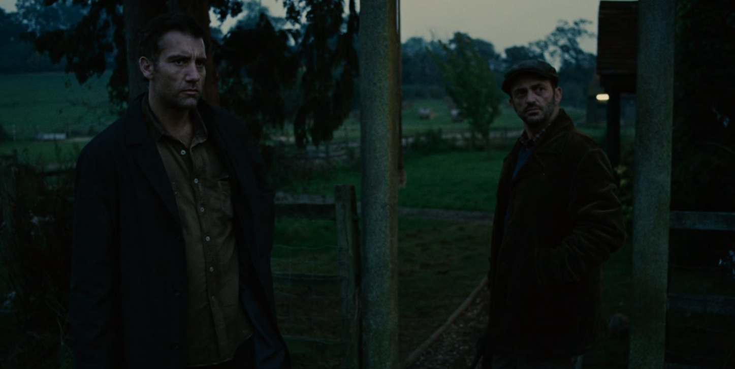 Tomasz and Theo stand together at the farmhouse in the wake of Julian's death.