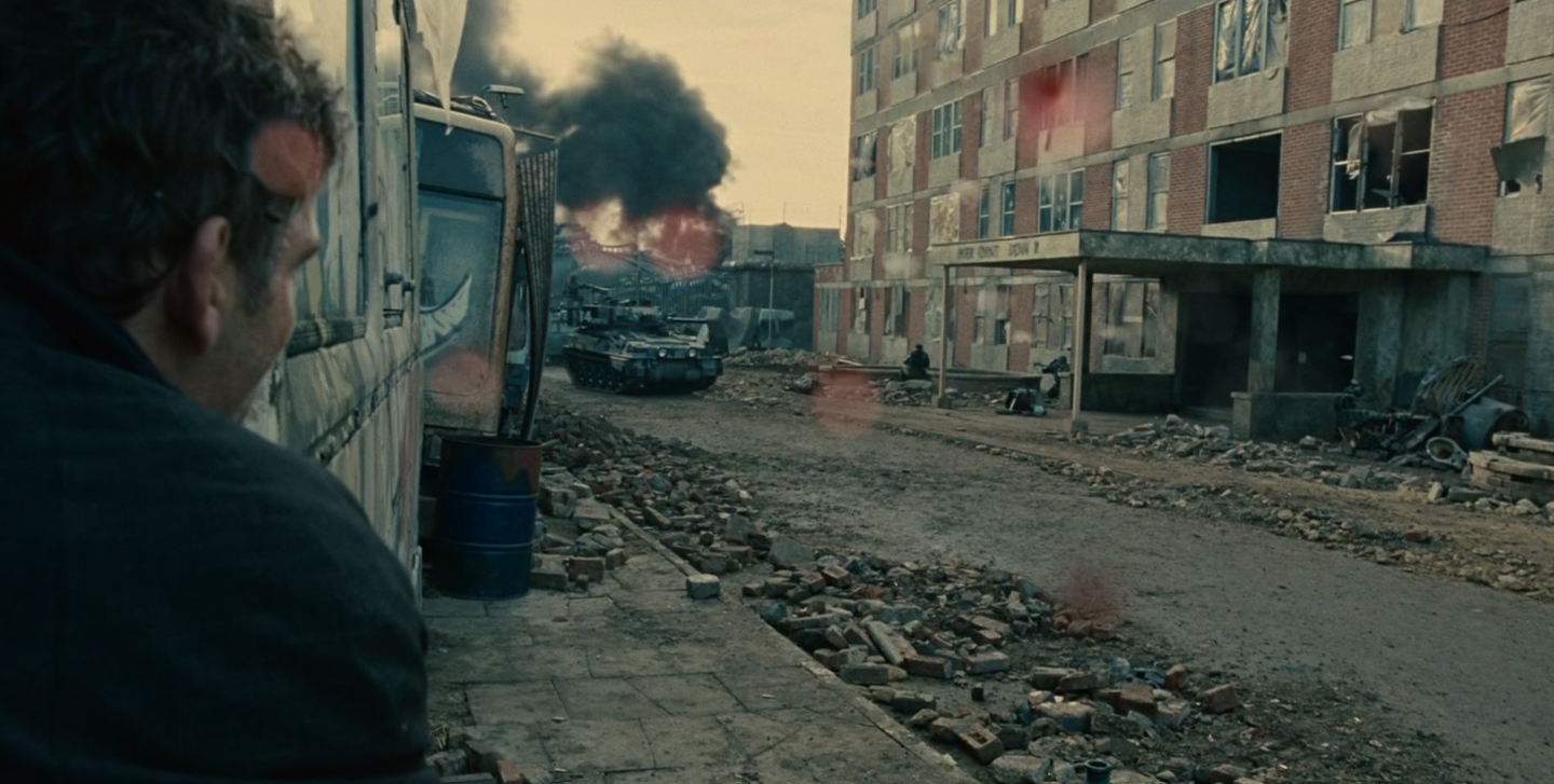 Theo moves through the battle in Bexhill as blood spatters the camera lens.
