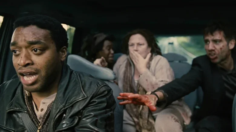 Theo, Kee, Luke and Miriam inside the car during the violent roadside ambush.
