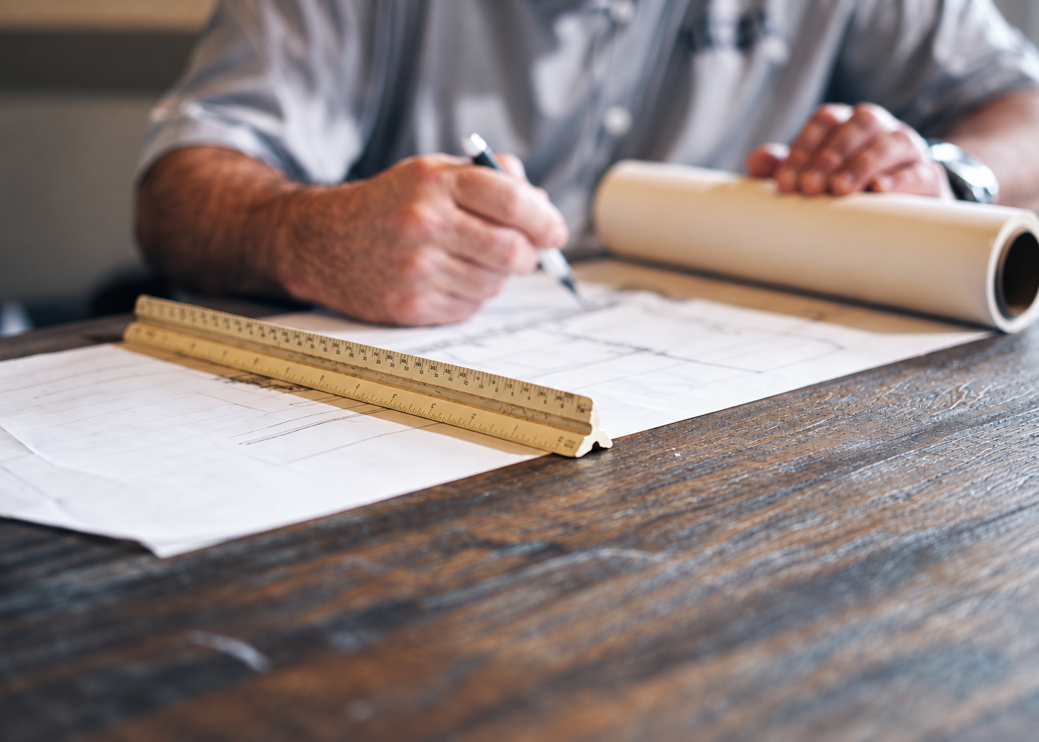 Designer drawing a garden plan by hand at the studio desk, David Eaton Associates
