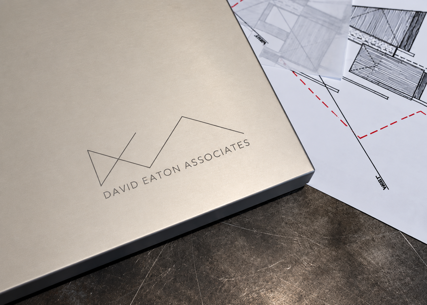 David Eaton Associates logo on a presentation box beside design drawings
