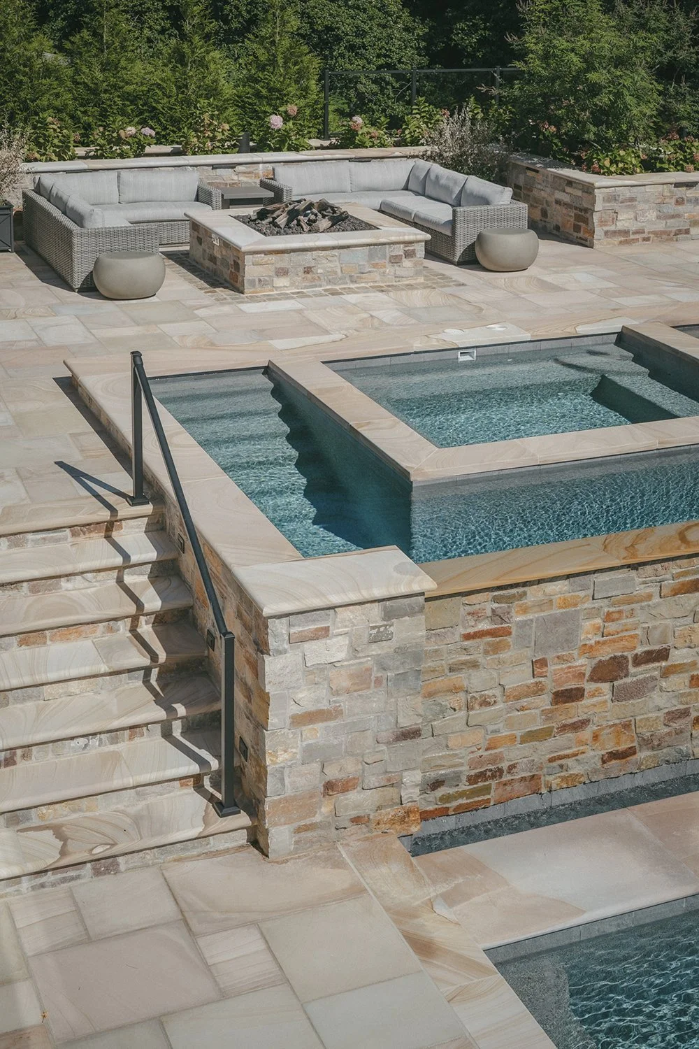 Raised spa set in stone beside the pool terrace, Riverfront Estate, Navesink River