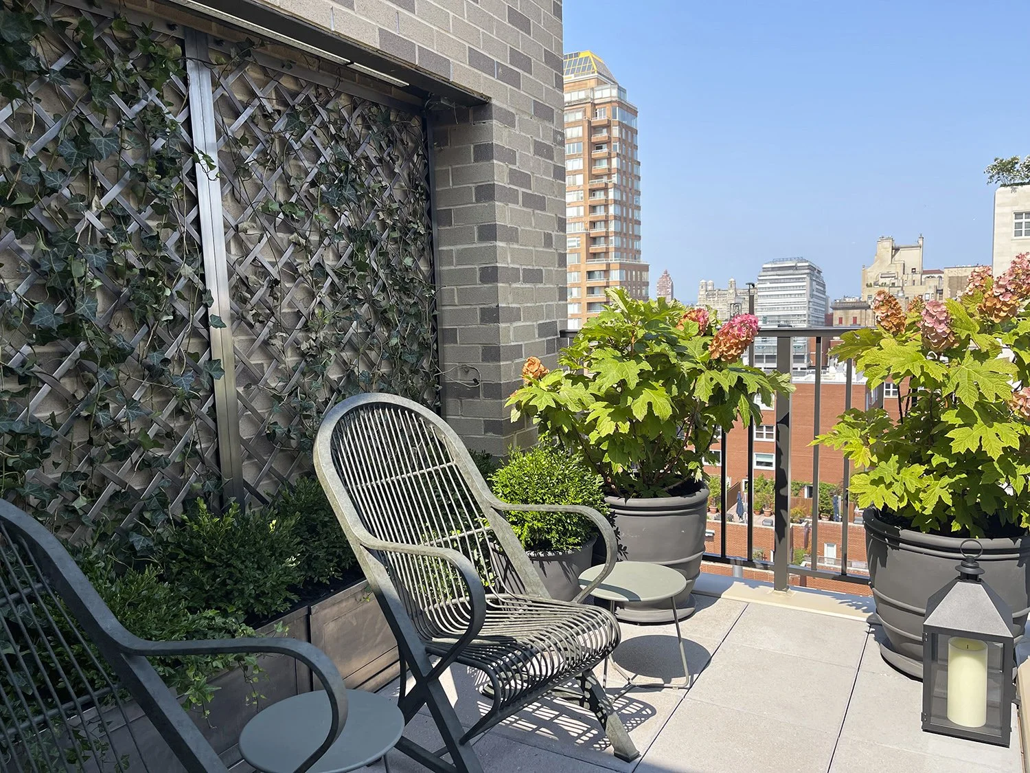 Seating area beside the ivy-covered blackened steel trellis, Park Avenue Penthouse