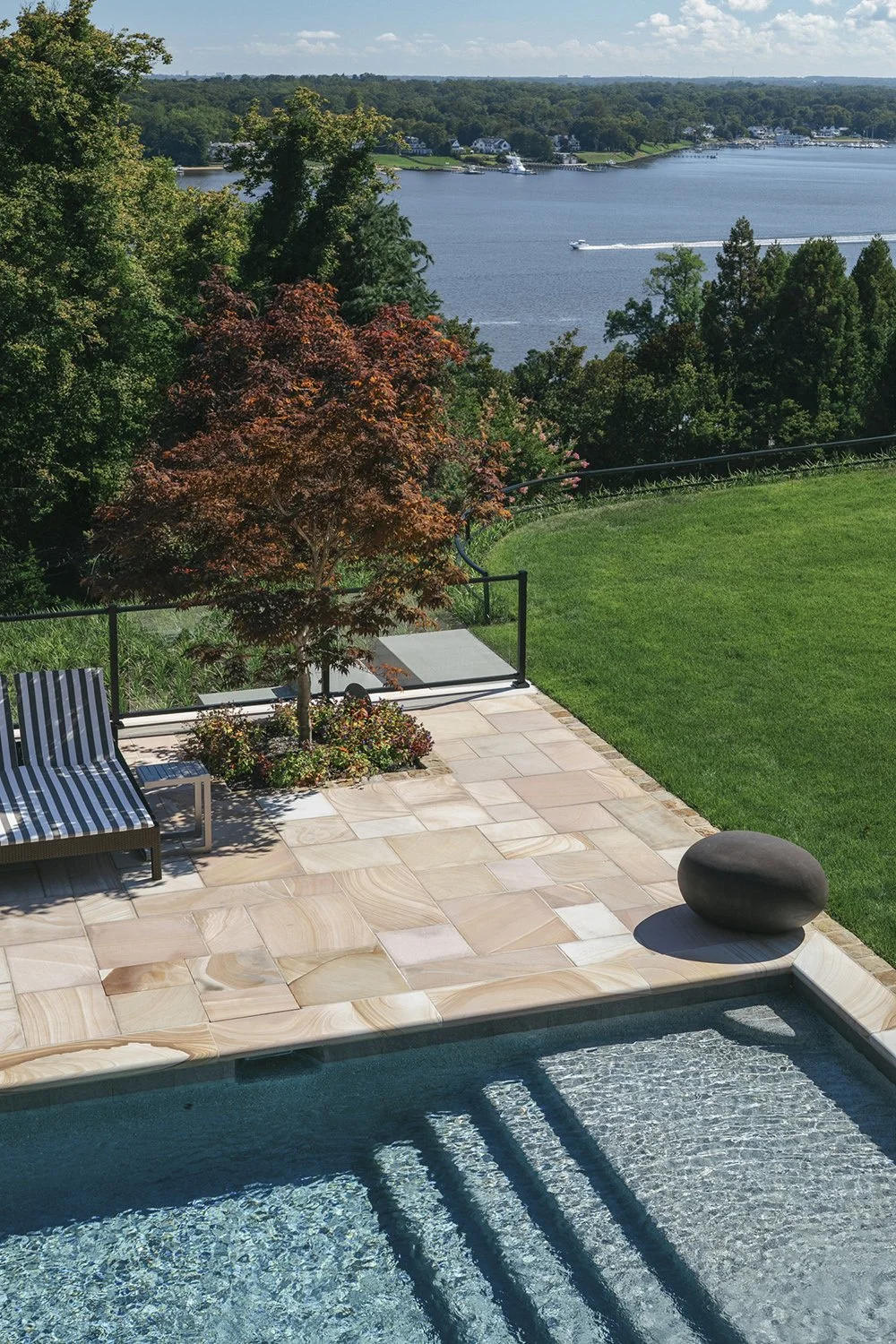 Pool steps and terrace with Japanese maples and the river beyond, Riverfront Estate, Navesink River