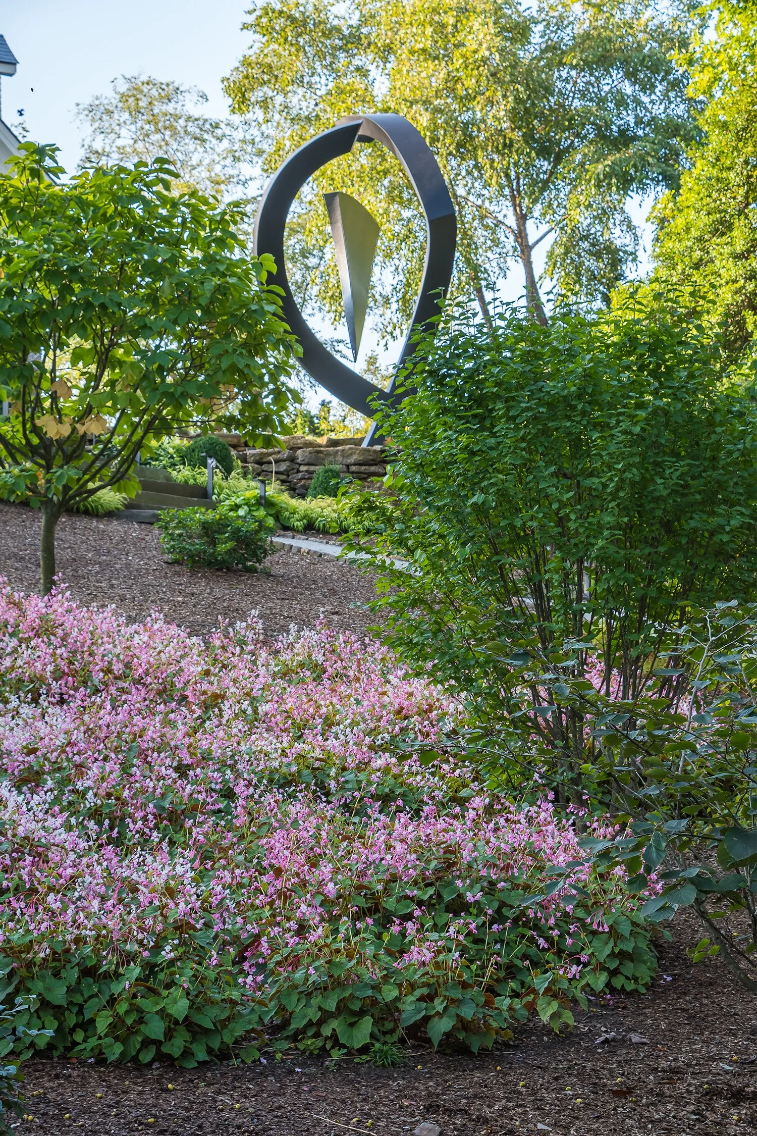 Sculpture rising from flowering groundcover in the woodland garden, Riverfront Estate, Navesink River