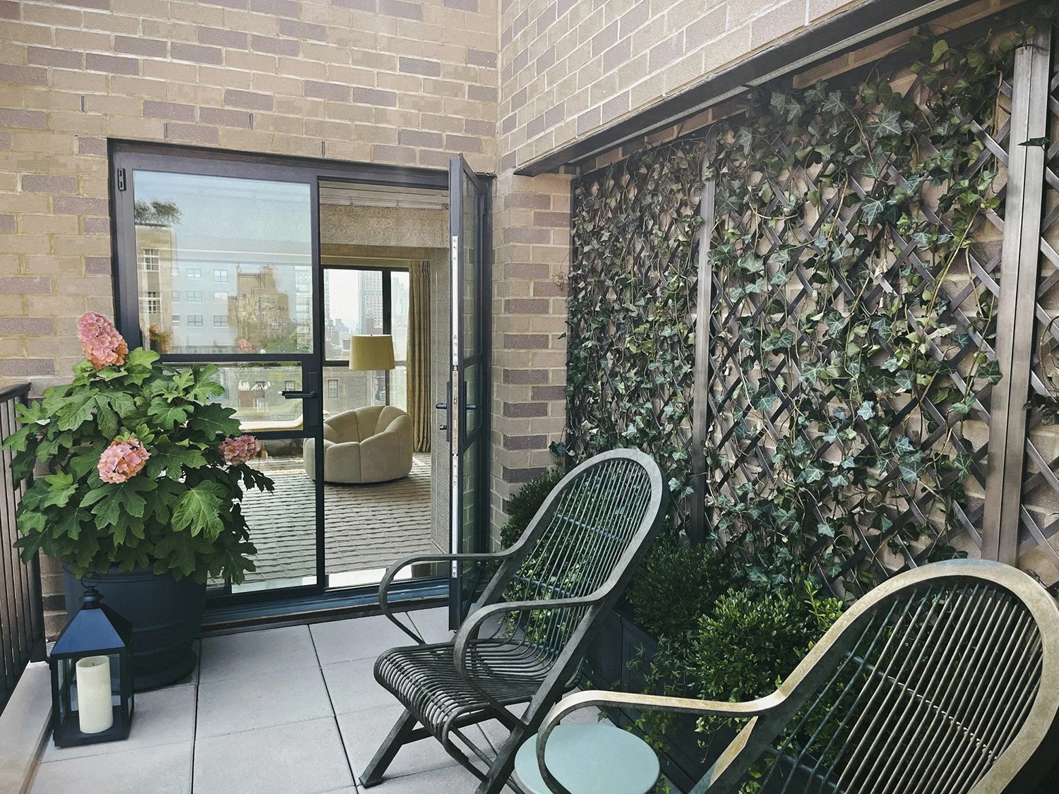 Garden chairs and a potted hibiscus beside the ivy trellis, Park Avenue Penthouse
