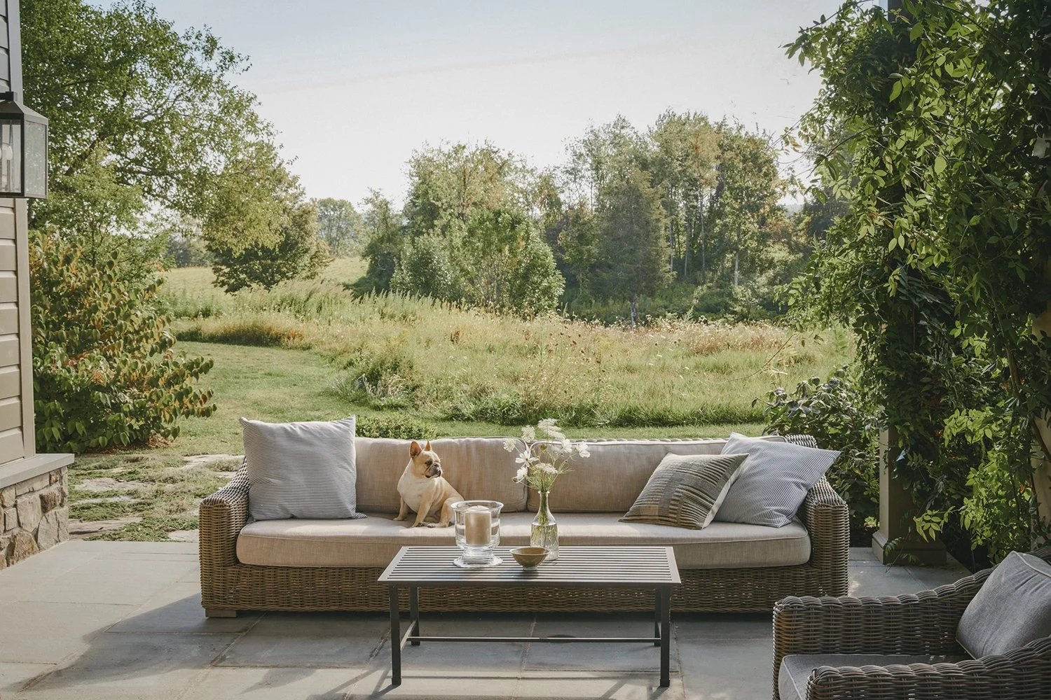 Outdoor sofa and coffee table overlooking the meadow, Hudson Valley Estate, Rhinebeck