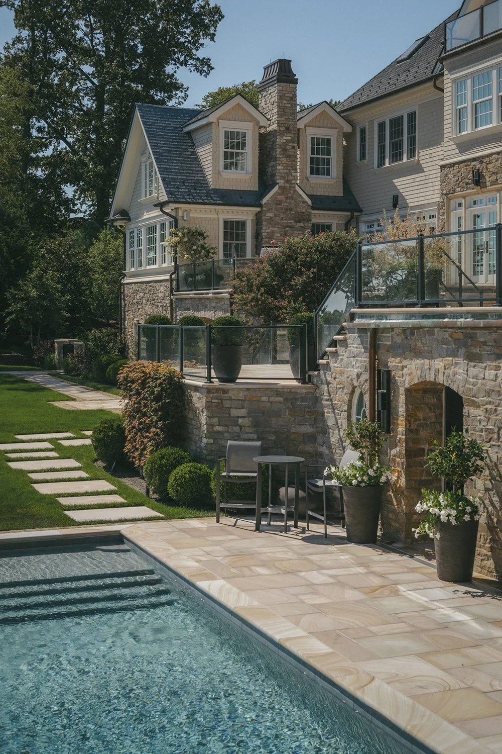 Pool edge beneath the stone facade of the house, Riverfront Estate, Navesink River