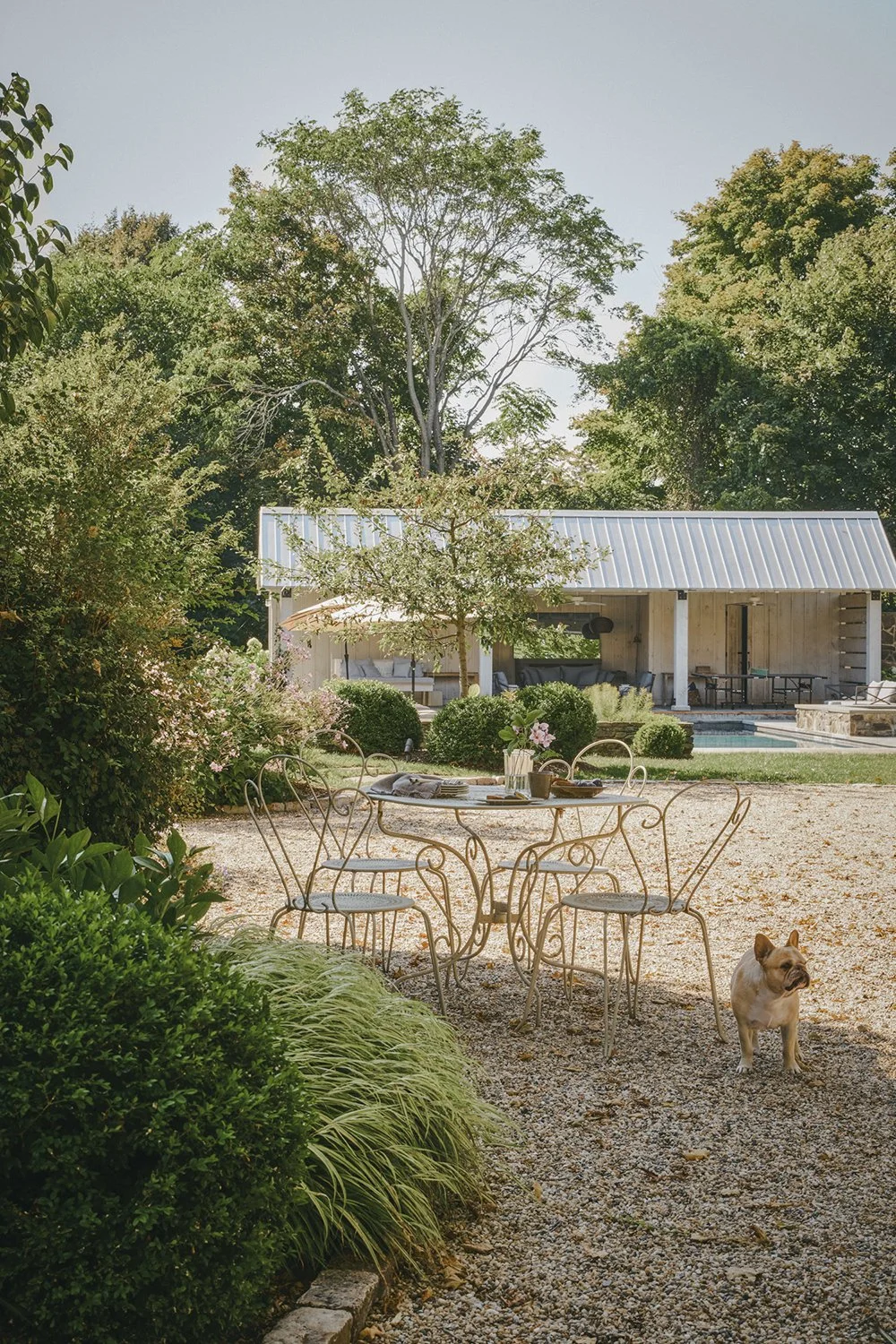 Gravel path leading toward the barn through layered planting, Hudson Valley Estate, Rhinebeck