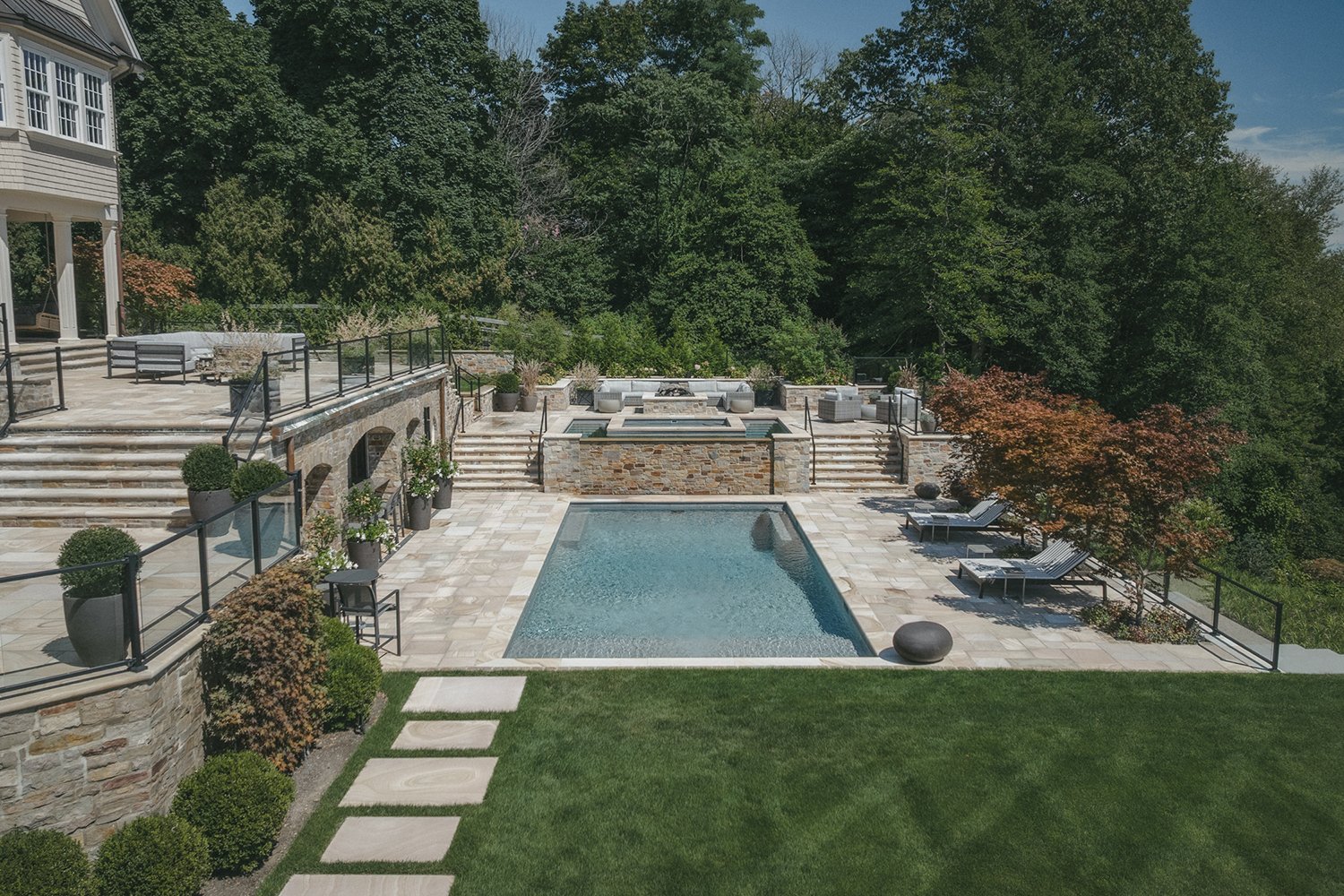 Stone stairways descending through terraces to the pool and lawn, Riverfront Estate, Navesink River