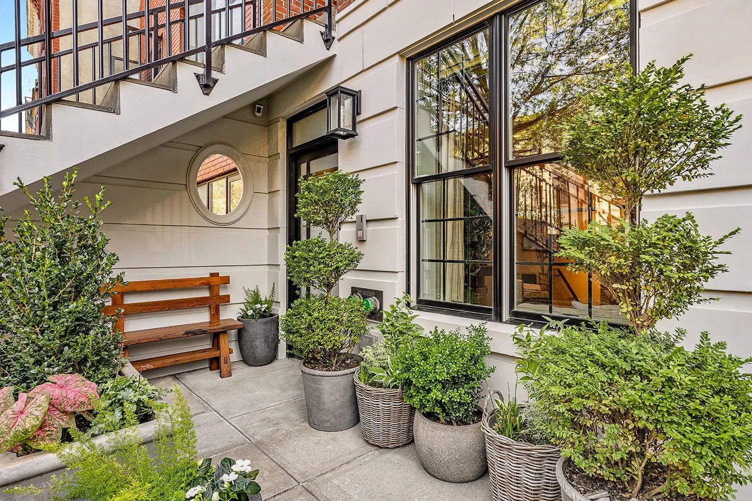 Front yard with a timber bench, potted evergreens and flowering hydrangeas, Townhouse Garden, Brooklyn