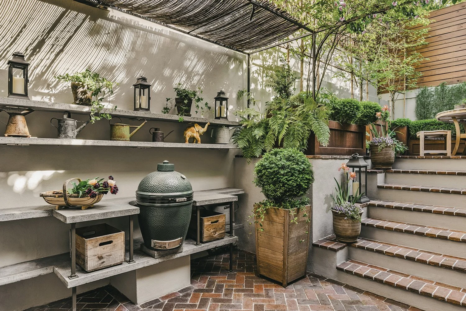Outdoor kitchen with concrete shelving and a Big Green Egg beside the brick steps, Townhouse Garden, Brooklyn
