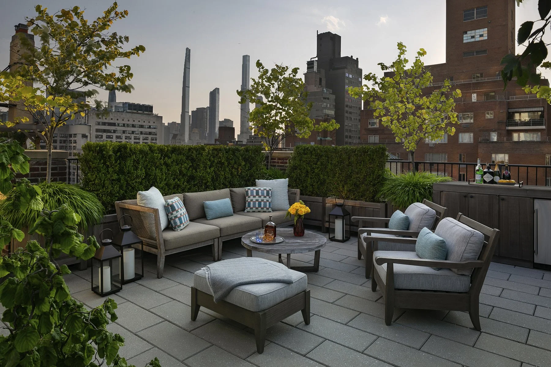Rooftop lounge seating with the Manhattan skyline at dusk, Upper East Side Penthouse