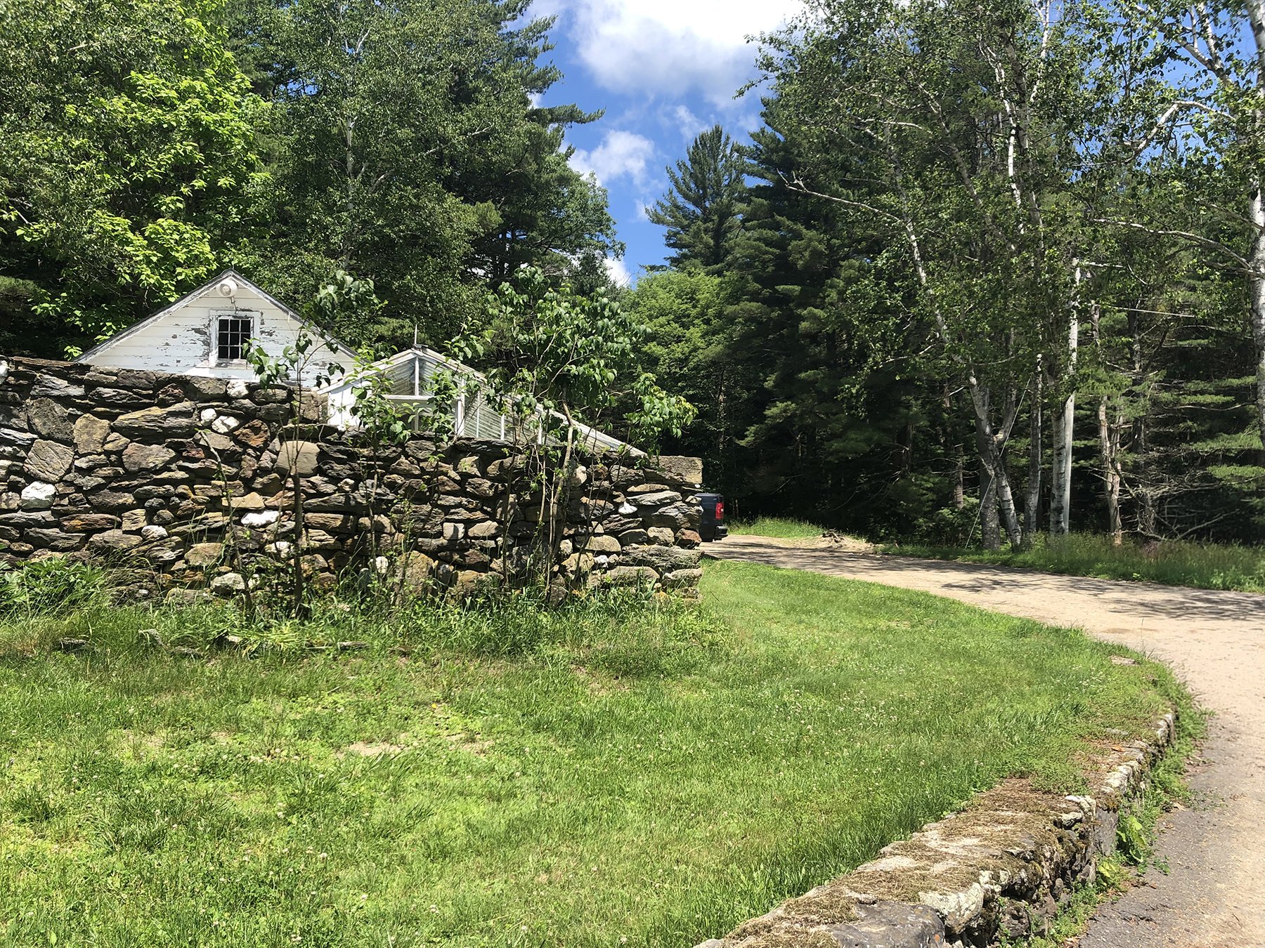 Dry stone wall beside a gravel path at the woodland edge, Mountain Retreat, Mt Washington MA