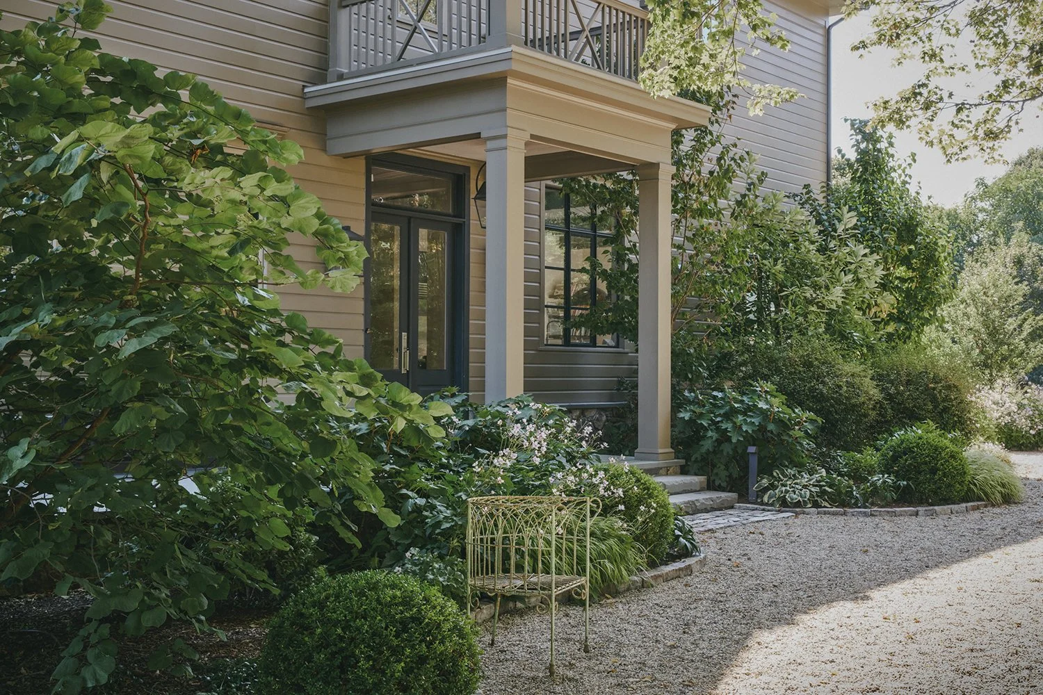 Perennial planting and a garden chair beside the house, Hudson Valley Estate, Rhinebeck